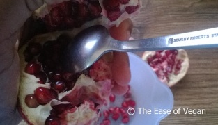 spooning out the Pomegranate seeds